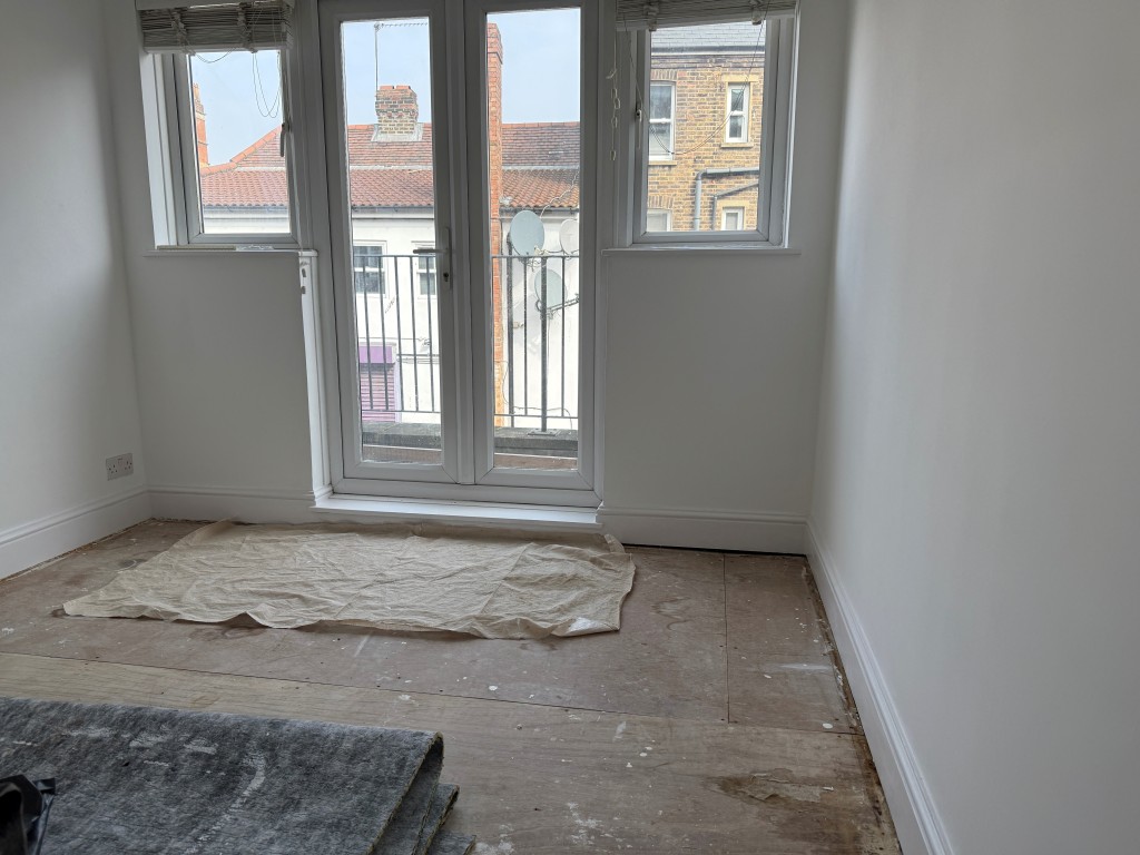 Lot: 196 - TWO-BEDROOM BALCONY FLAT IN CENTRAL LOCATION - Main rear bedroom with glazed double doors to sun balcony